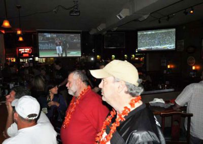 Men wearing leis at bar