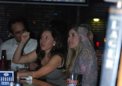 Lakewood Sports Pub - Woman Enjoying NBA Game with Craft Beer at The Pour House Dallas